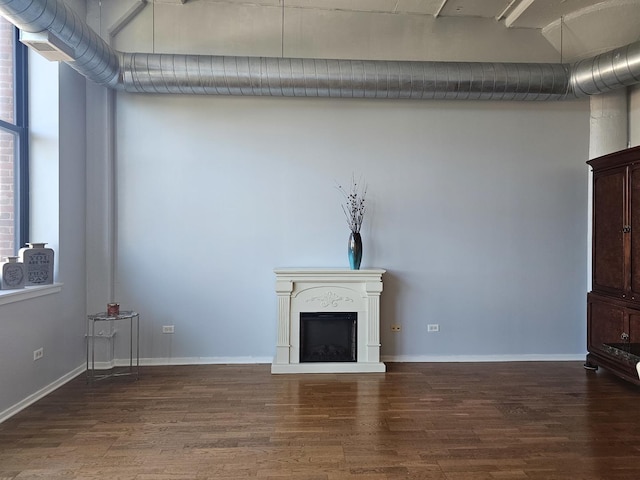 unfurnished living room with dark hardwood / wood-style flooring