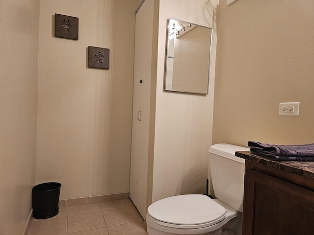 bathroom with tile patterned flooring, vanity, and toilet