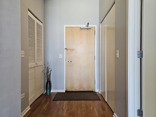 hallway with dark hardwood / wood-style floors