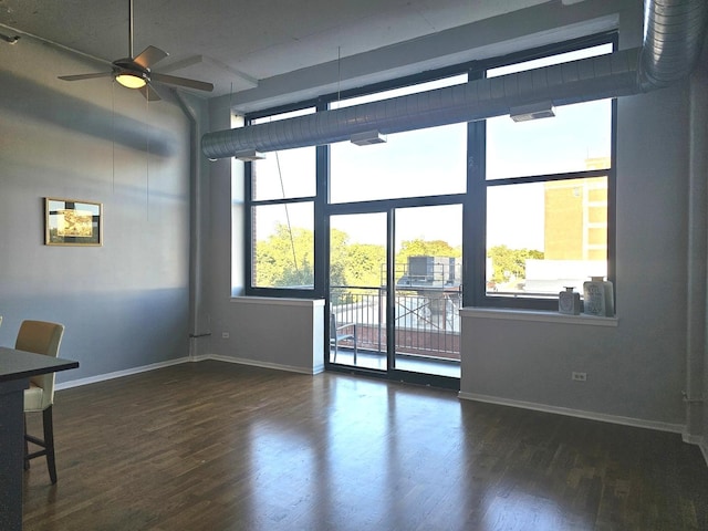 unfurnished room featuring ceiling fan and dark hardwood / wood-style flooring