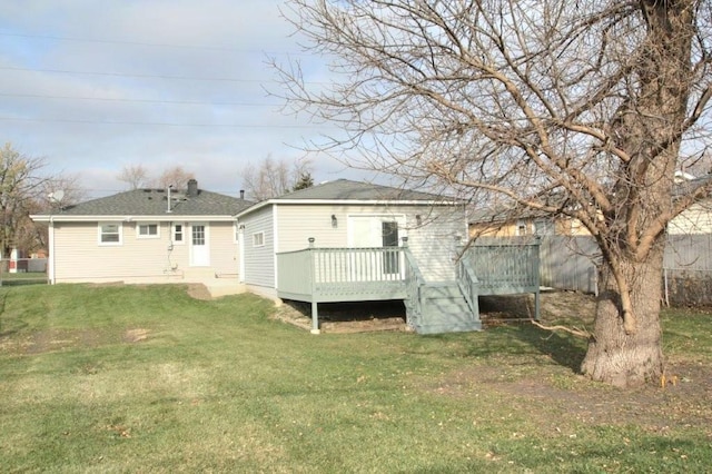 back of house with a wooden deck and a lawn