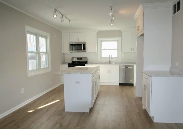 kitchen with white cabinetry, sink, decorative backsplash, and appliances with stainless steel finishes