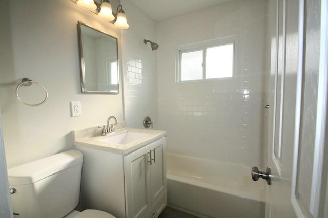 full bathroom with vanity, tiled shower / bath combo, and toilet