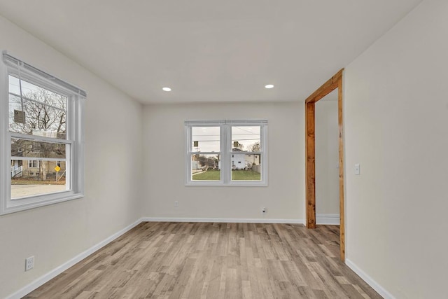 unfurnished room with light hardwood / wood-style floors