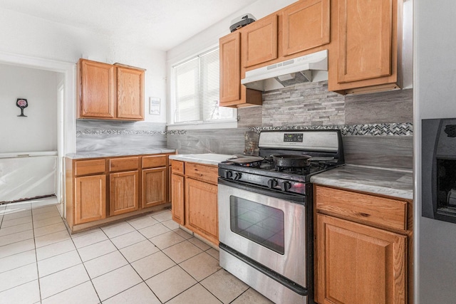 kitchen with gas stove, decorative backsplash, and light tile patterned floors