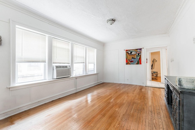 unfurnished dining area featuring ornamental molding, a wealth of natural light, and light hardwood / wood-style flooring