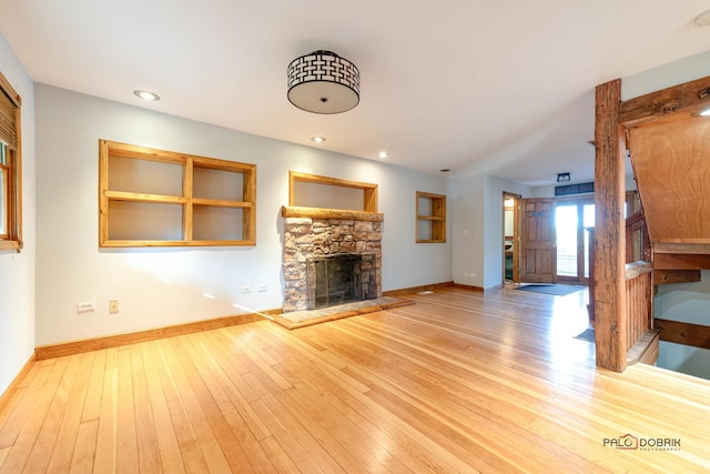 unfurnished living room with light hardwood / wood-style floors and a fireplace