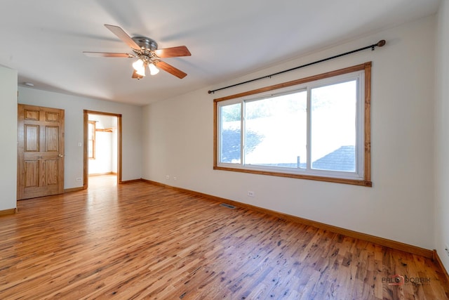 spare room with light hardwood / wood-style flooring and ceiling fan