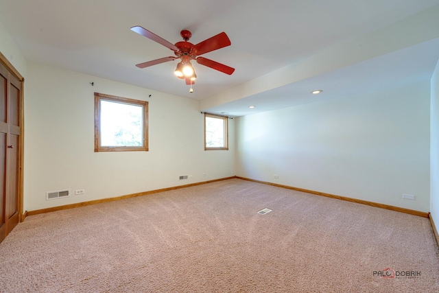 carpeted spare room with ceiling fan