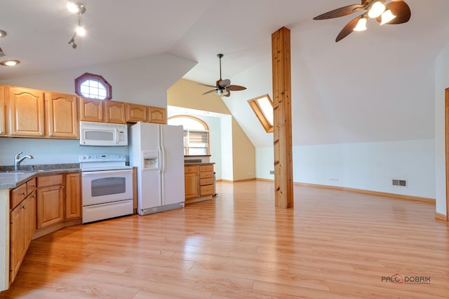 kitchen featuring light wood-type flooring, a skylight, white appliances, ceiling fan, and sink