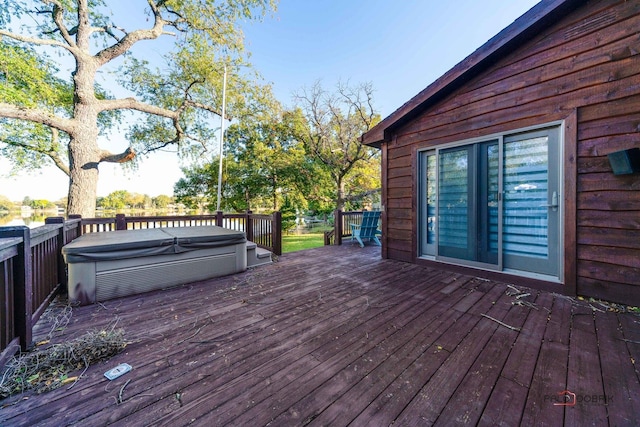 wooden deck with a covered hot tub