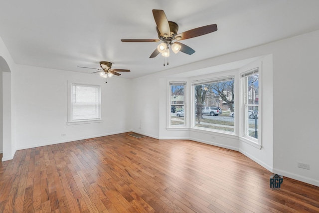 spare room featuring hardwood / wood-style floors, plenty of natural light, and ceiling fan