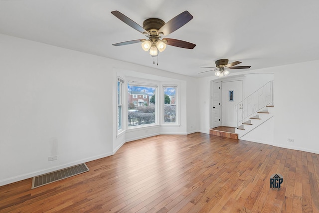 unfurnished living room with light wood-type flooring and ceiling fan