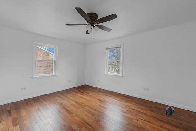 unfurnished room with wood-type flooring, plenty of natural light, and ceiling fan