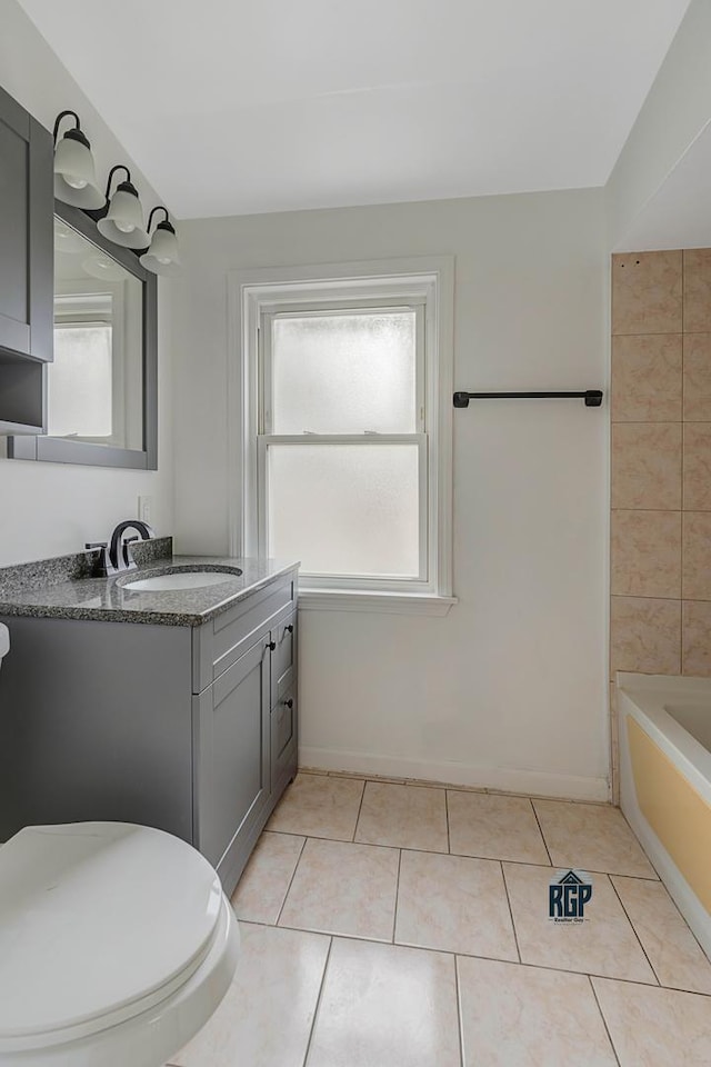 bathroom featuring tile patterned floors, vanity, and toilet