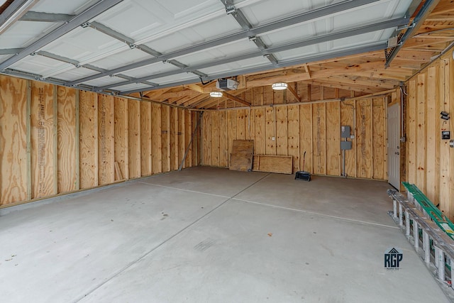 garage with wooden walls and a garage door opener