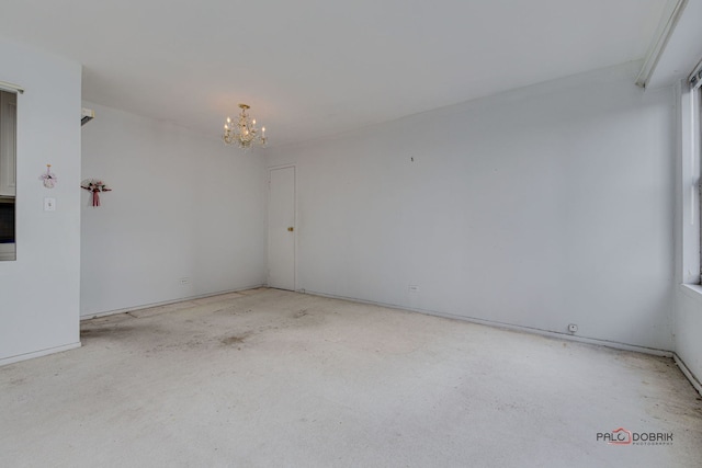 spare room with an inviting chandelier