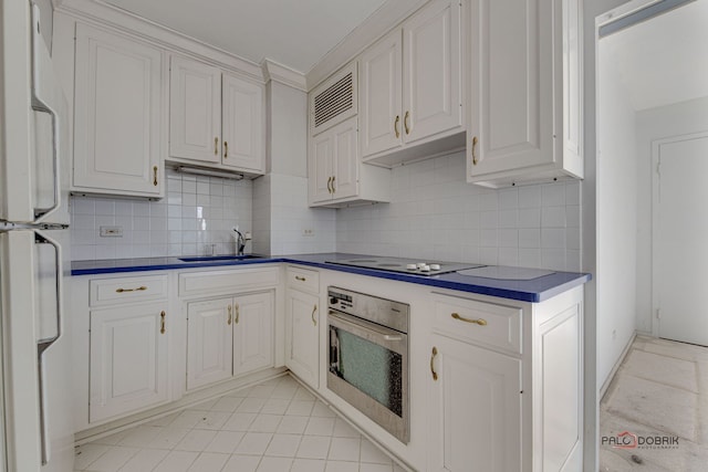 kitchen with white cabinetry, white appliances, sink, and decorative backsplash