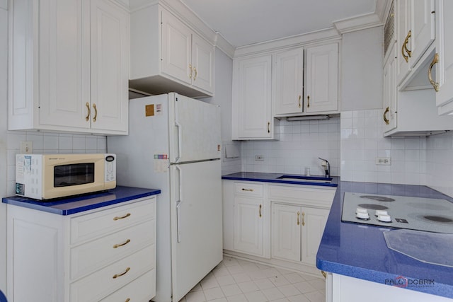 kitchen featuring sink, white appliances, and white cabinets