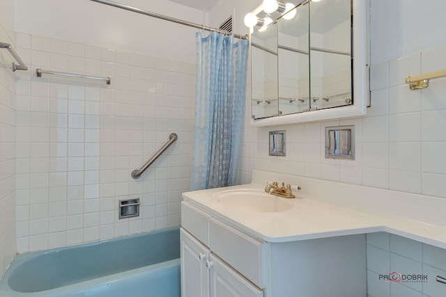 bathroom with shower / tub combo with curtain, tile walls, tasteful backsplash, and vanity