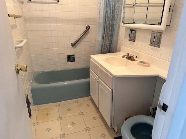 full bathroom with shower / tub combo, tile walls, backsplash, tile patterned floors, and vanity