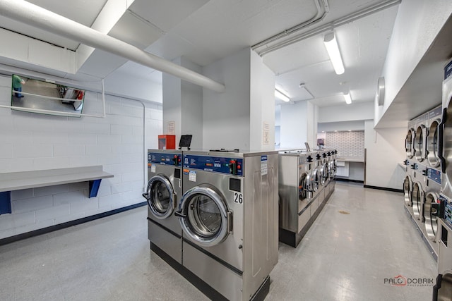 washroom featuring washer and dryer and stacked washing maching and dryer