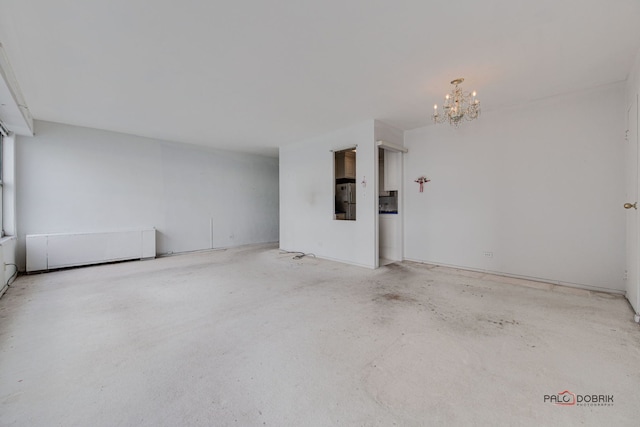 unfurnished room with a chandelier