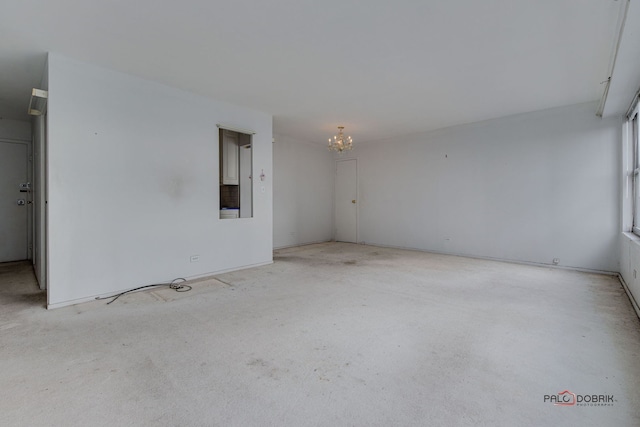 unfurnished room with a notable chandelier