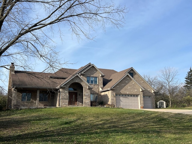 view of front of home featuring a front yard and a garage