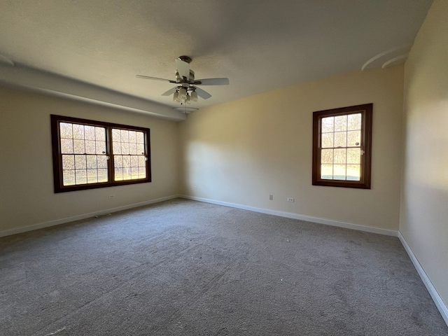 unfurnished room featuring carpet flooring, ceiling fan, and a healthy amount of sunlight