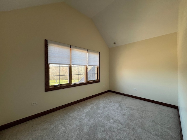 unfurnished room featuring light colored carpet and lofted ceiling