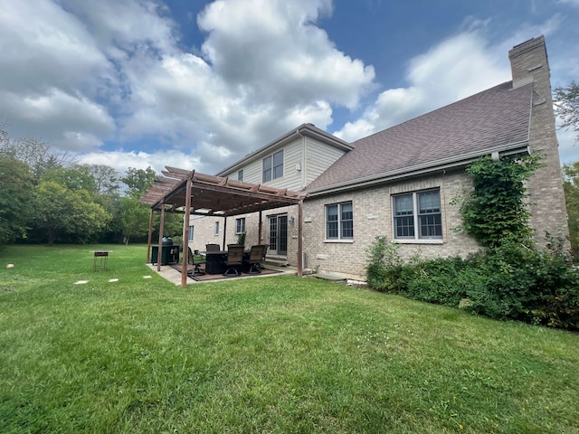 rear view of property featuring a pergola, a lawn, and a patio