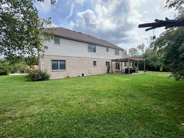 back of property featuring a lawn, a pergola, and central air condition unit