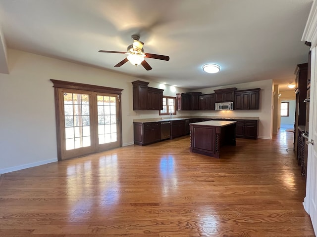 kitchen with dark brown cabinetry, hardwood / wood-style floors, and a kitchen island