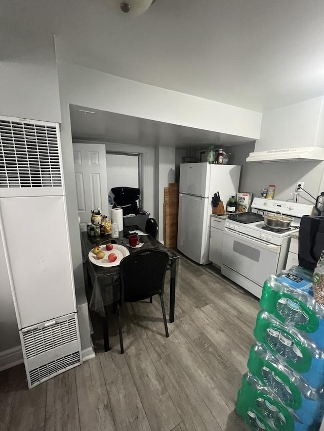 kitchen with wood-type flooring and white appliances