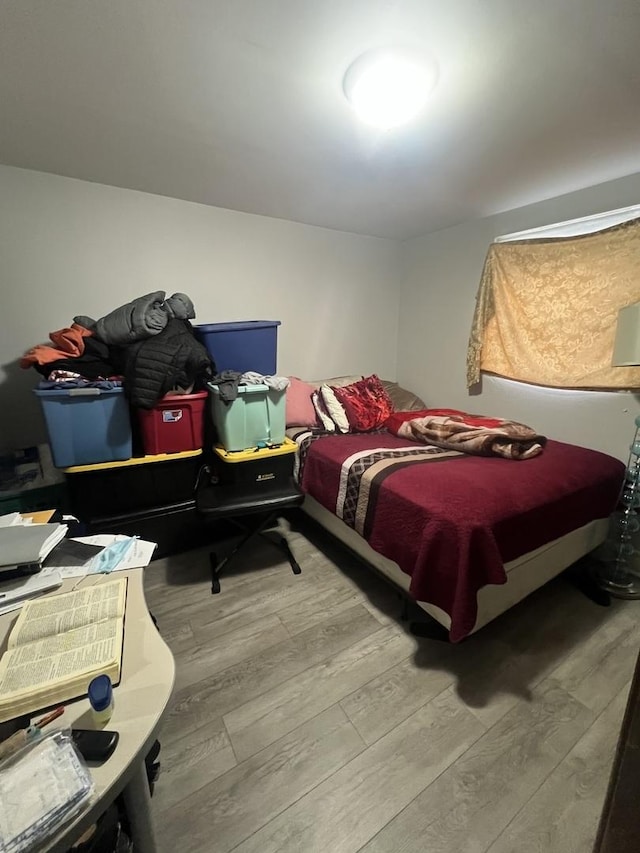 bedroom with wood-type flooring