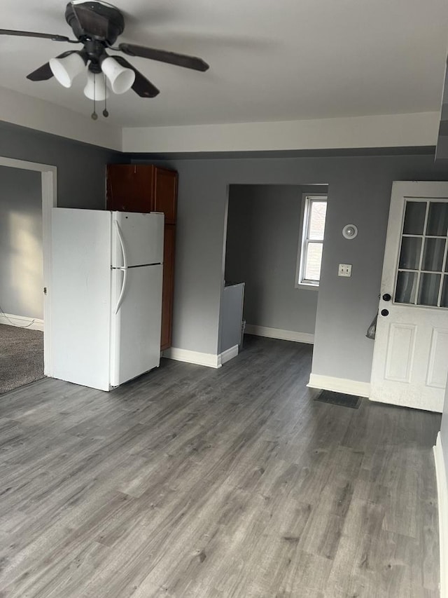 kitchen with white fridge, ceiling fan, and hardwood / wood-style flooring