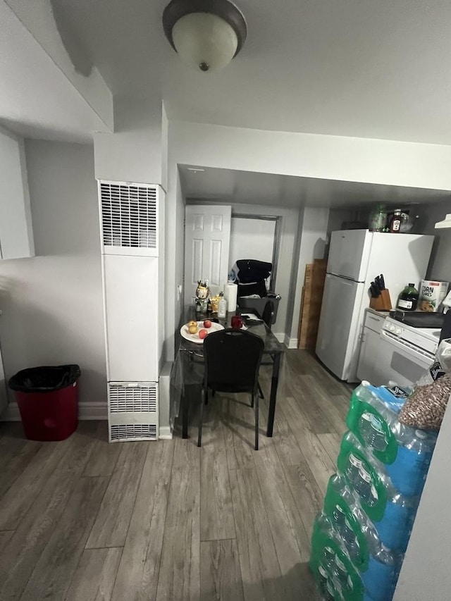 kitchen featuring white refrigerator, hardwood / wood-style flooring, and fridge