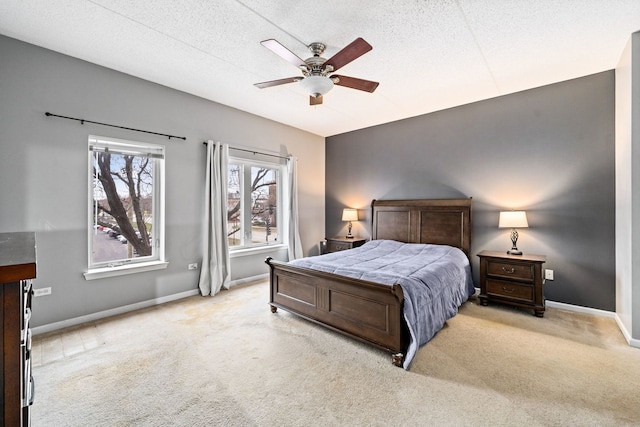 carpeted bedroom with ceiling fan and a textured ceiling