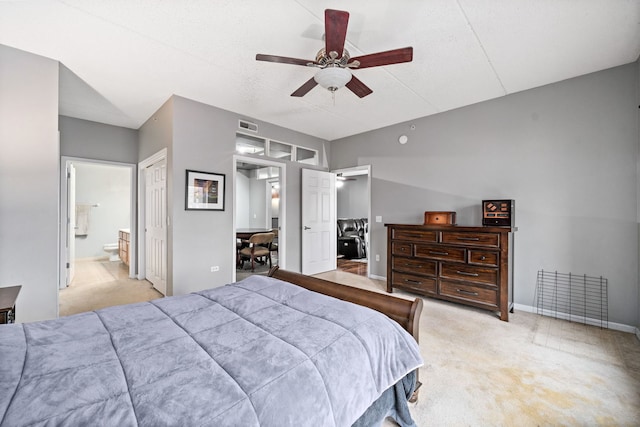 bedroom featuring ensuite bathroom, a closet, ceiling fan, and light colored carpet