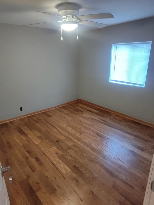 unfurnished room featuring hardwood / wood-style flooring and ceiling fan