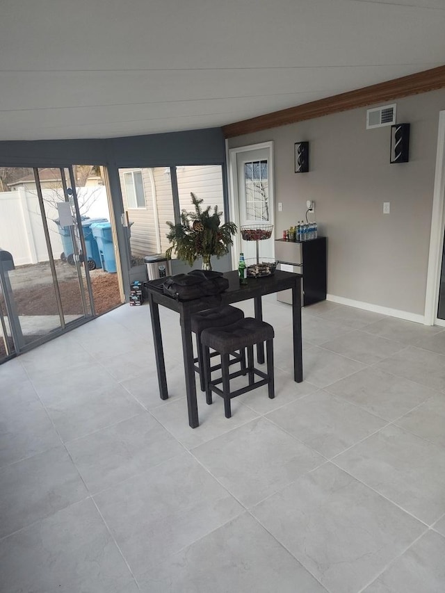 tiled dining room with ornamental molding