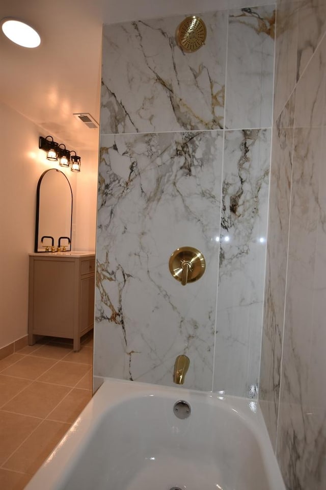 bathroom with tiled shower / bath combo and tile patterned floors