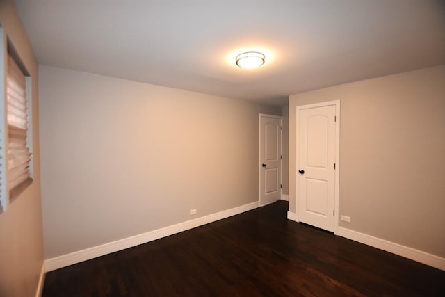 spare room featuring dark hardwood / wood-style flooring