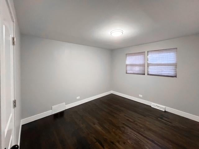 empty room featuring dark wood-type flooring