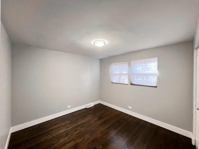 empty room with hardwood / wood-style flooring