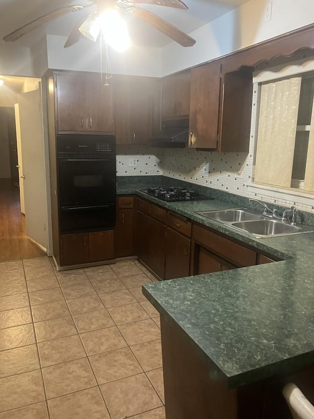 kitchen with dark brown cabinetry, sink, backsplash, black gas stovetop, and light tile patterned floors