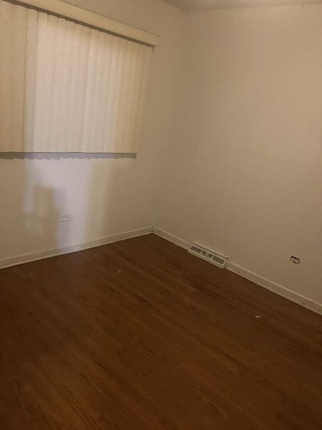 spare room with dark hardwood / wood-style floors