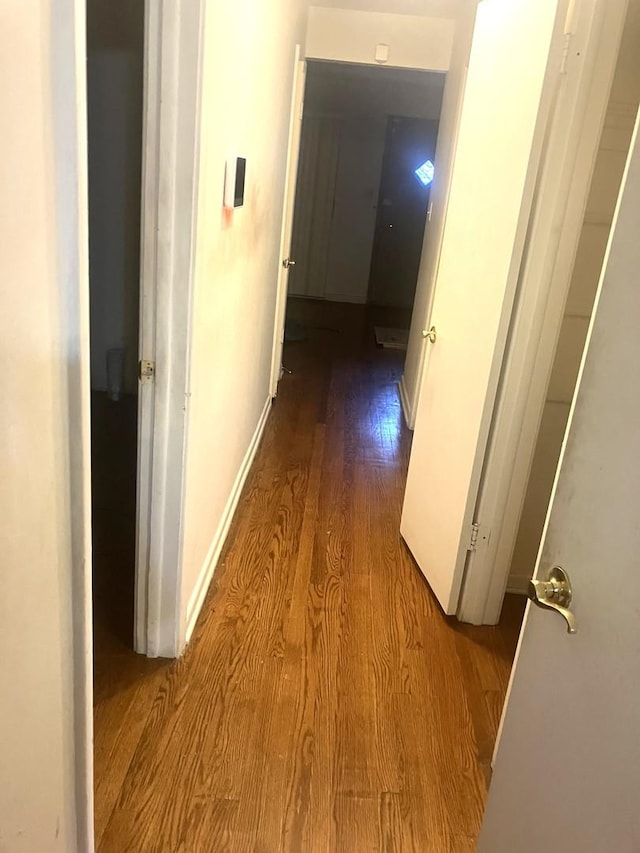 hallway with light hardwood / wood-style floors