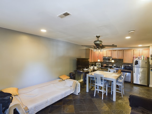 kitchen featuring decorative backsplash, stainless steel appliances, and ceiling fan